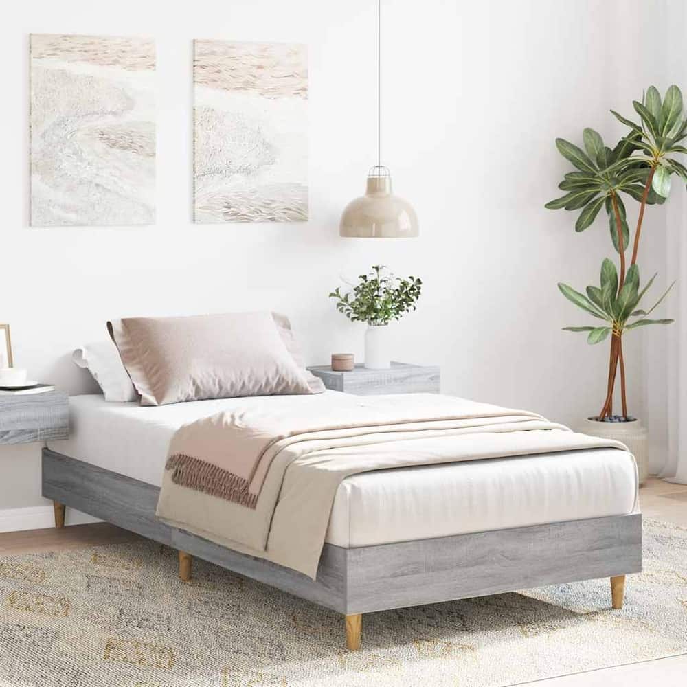 The single bed frame in a bedroom setting with bedside tables and artwork on the wall