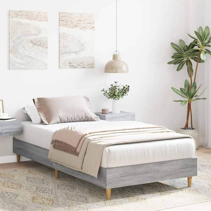 The single bed frame in a bedroom setting with bedside tables and artwork on the wall