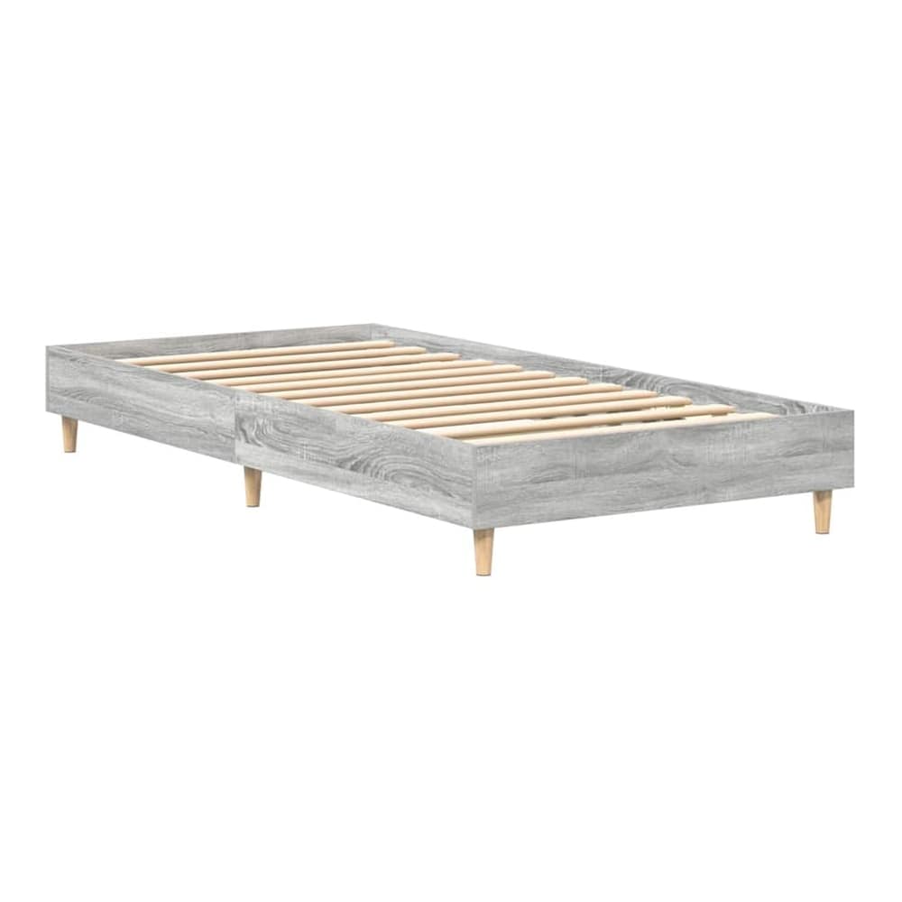 The bed frame without a mattress, showing the wooden slatted base and grey engineered wood construction