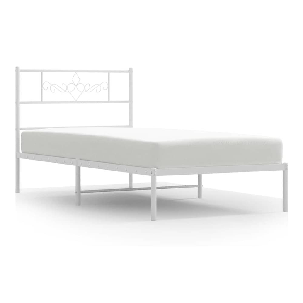 The white metal bed frame with a decorative headboard