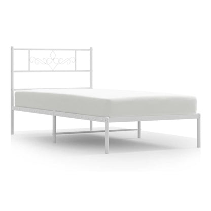 The white metal bed frame with a decorative headboard