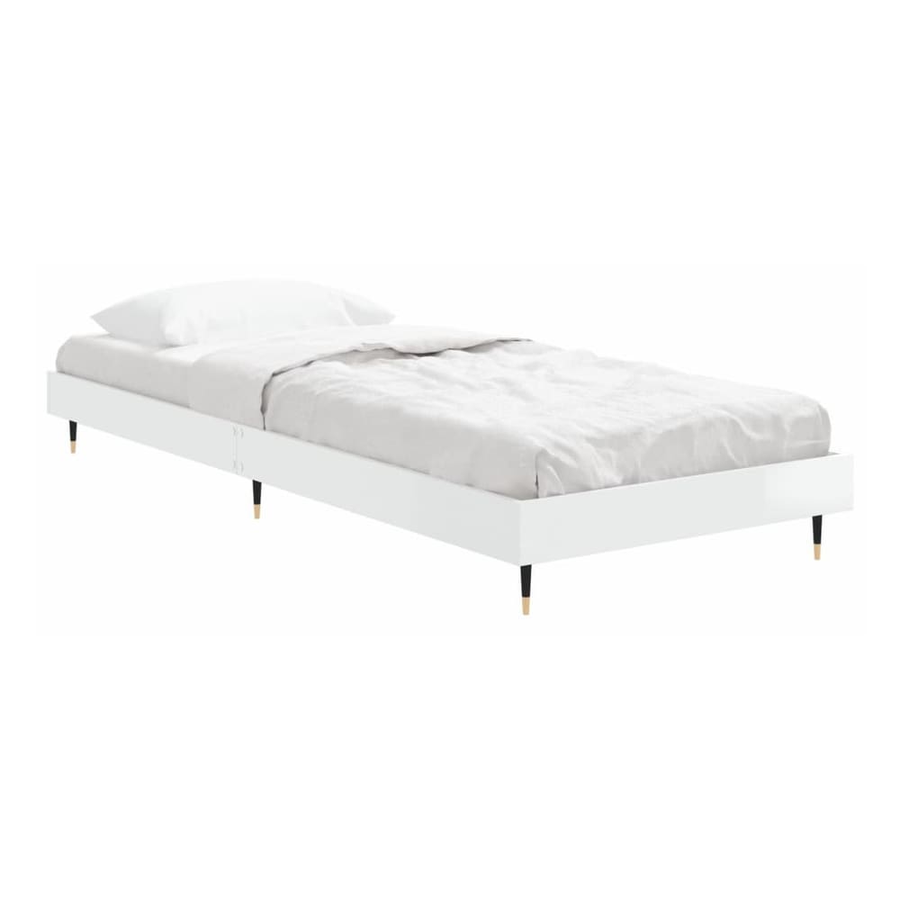 the white high gloss bed frame without mattress with bedding and a blanket