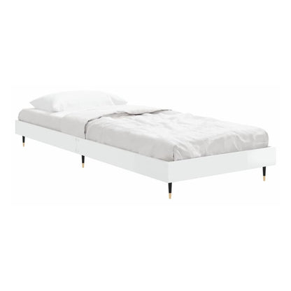 the white high gloss bed frame without mattress with bedding and a blanket