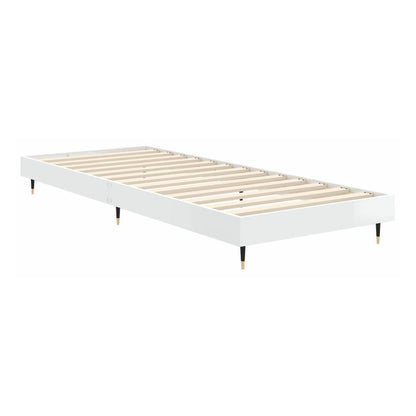 the white high gloss bed frame without mattress with the wooden slats visible