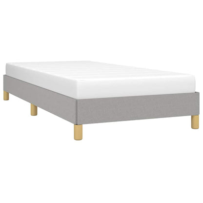 The light grey fabric bed frame with a white mattress on top, angled view