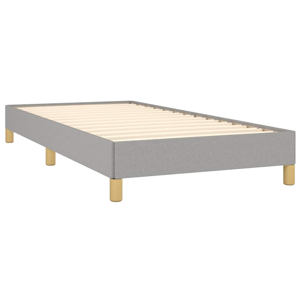 The light grey fabric bed frame without a mattress, showing the wooden slats