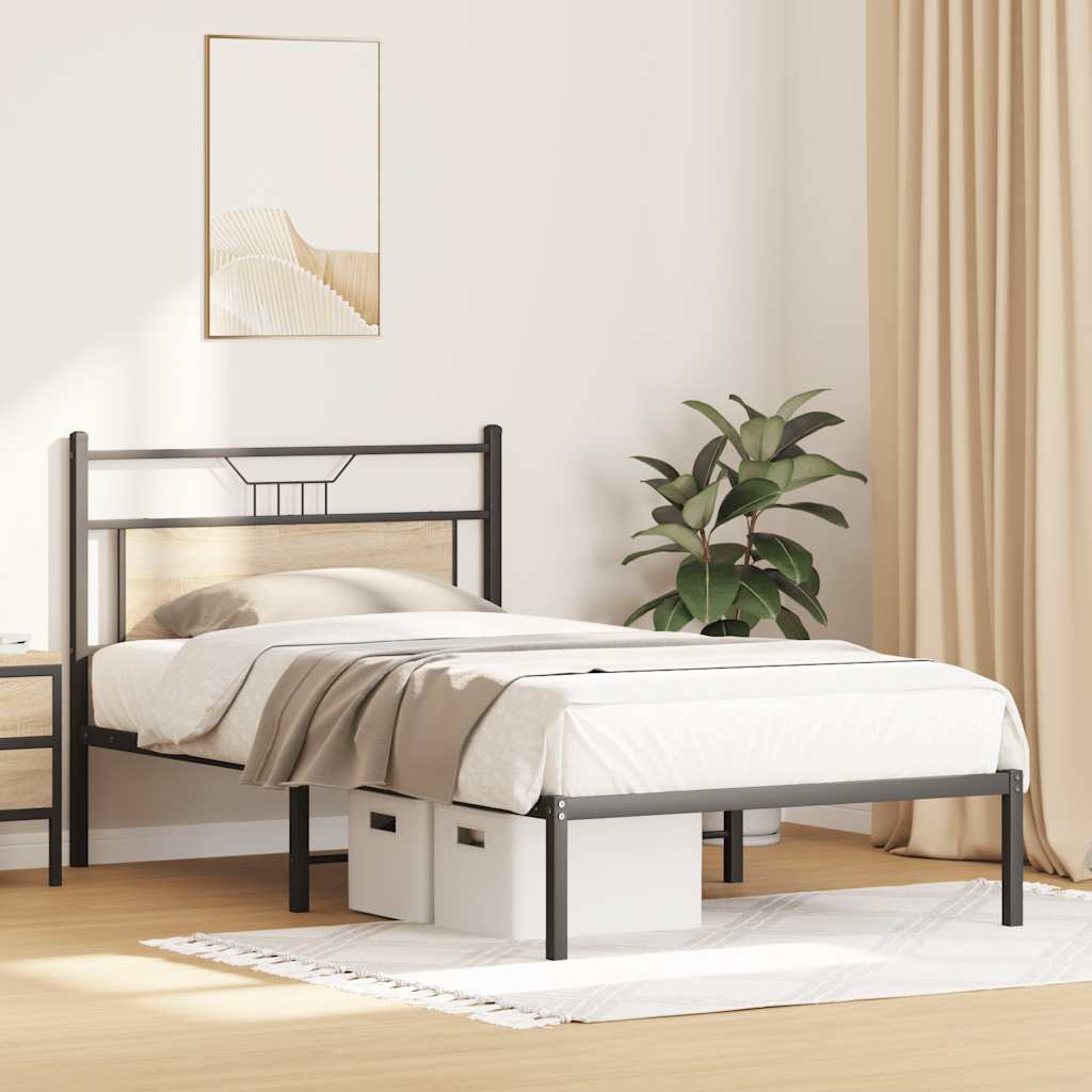 The bed frame in a bedroom setting with storage boxes underneath and a plant beside it