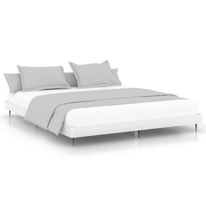 The white bed frame dressed with a mattress and grey bedding on a plain white background
