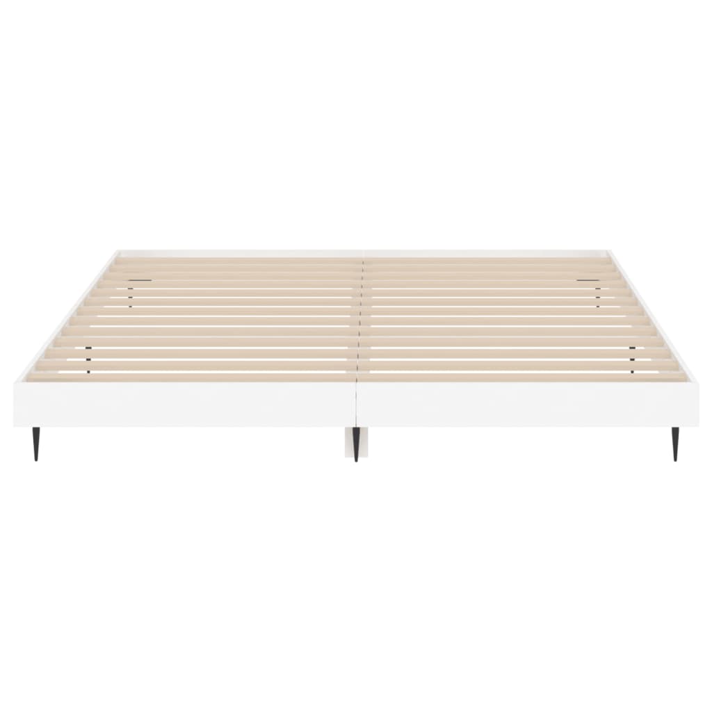 The white bed frame viewed from the front showing the slatted base and support legs