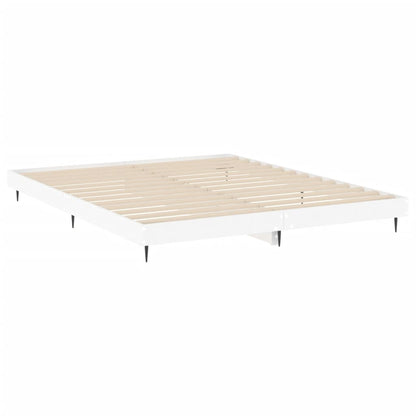 The white bed frame showing the wooden slats and thin black legs on a white background