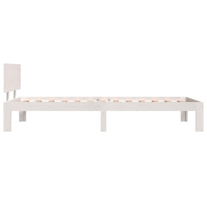 The white bed frame seen from the side showing the legs and headboard