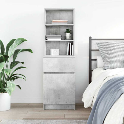 The bedside cabinet in a bedroom with a plant and a bed