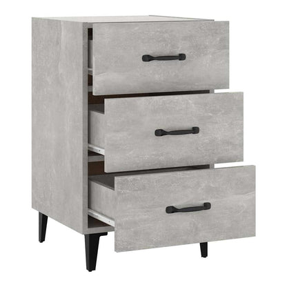The bedside table with three drawers, two of which are open showing the inside