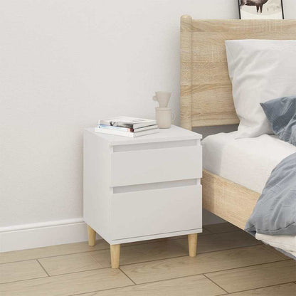 A white bedside cabinet with two drawers, placed next to a bed