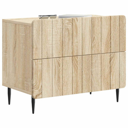 The bedside table featuring a light wood surface with a pair of glasses resting on top
