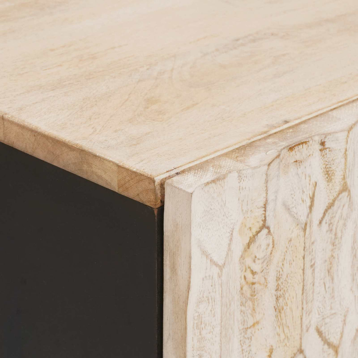Close up of the carved wood texture on the bedside cabinet drawer