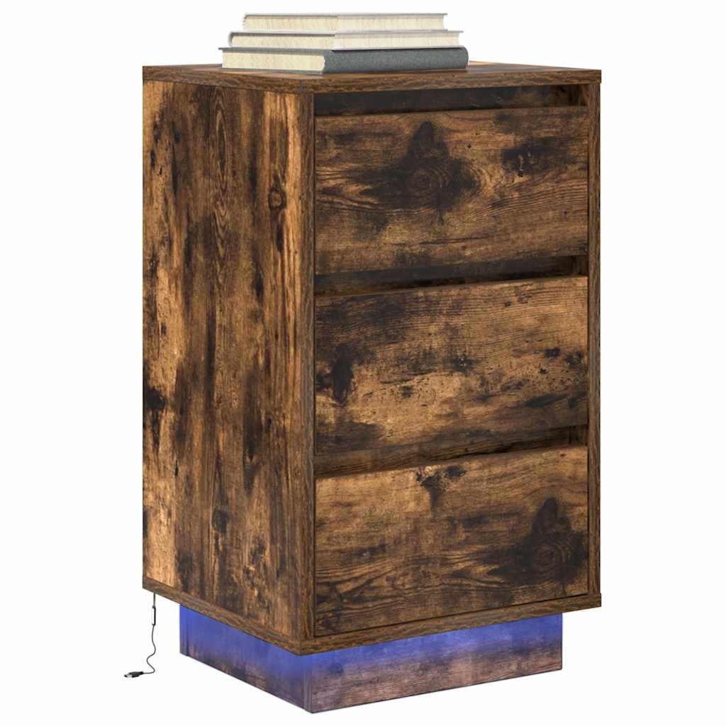 The bedside table with blue base lighting and books stacked on the top surface