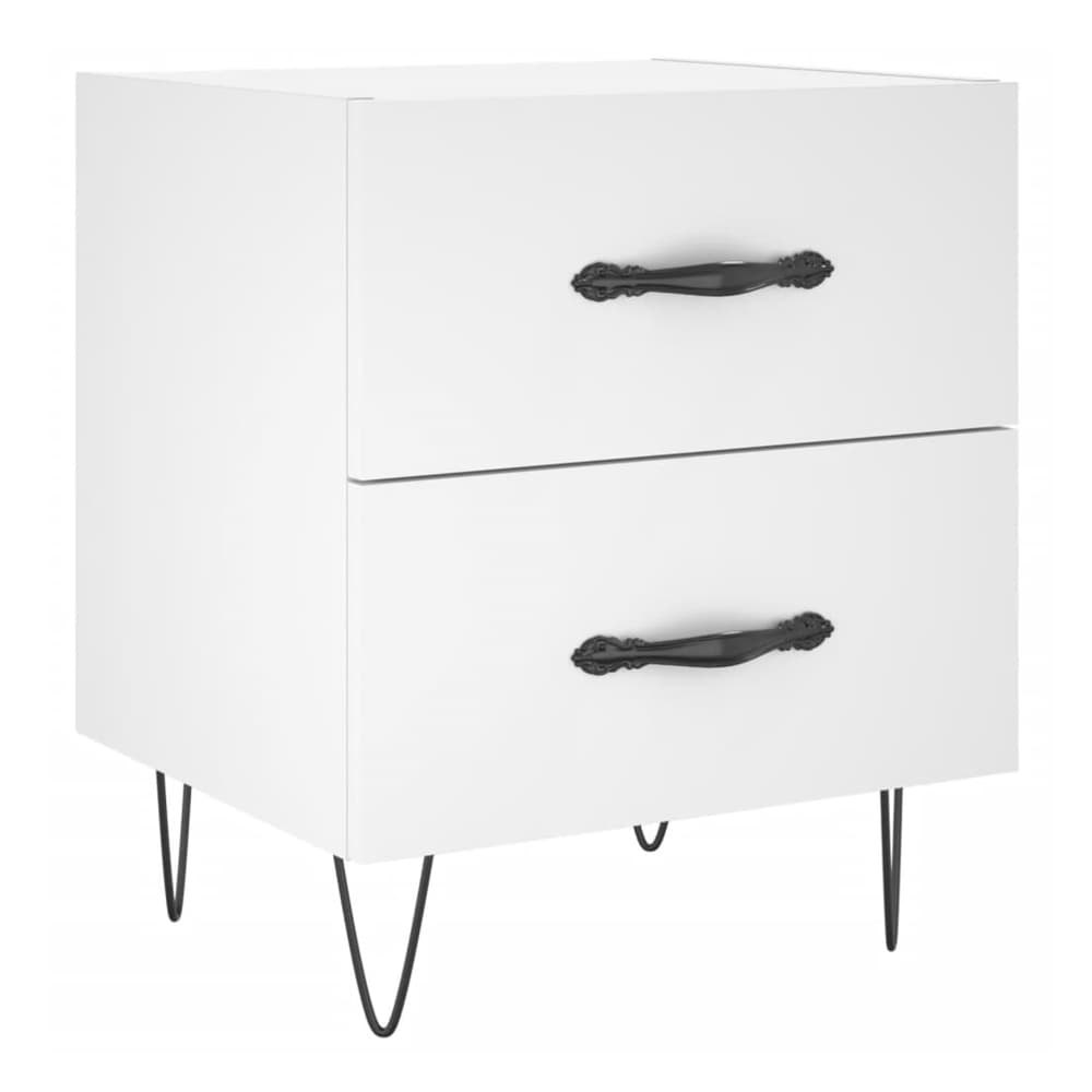 Close-up of the decorative black handles on the drawers of a white bedside cabinet