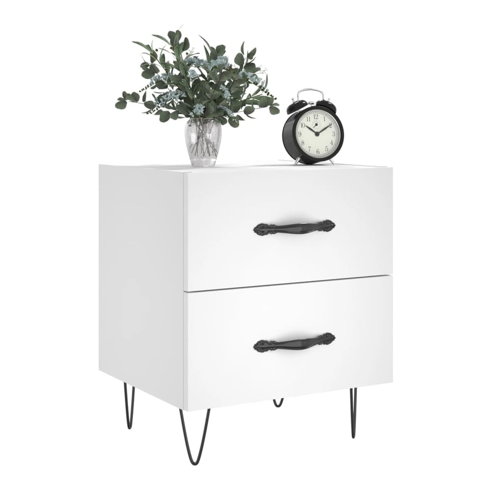 A white bedside cabinet with two drawers and black hairpin legs, decorated with a vase and clock