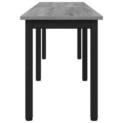 The narrow bench showing the grey wood grain surface and black frame from a side perspective