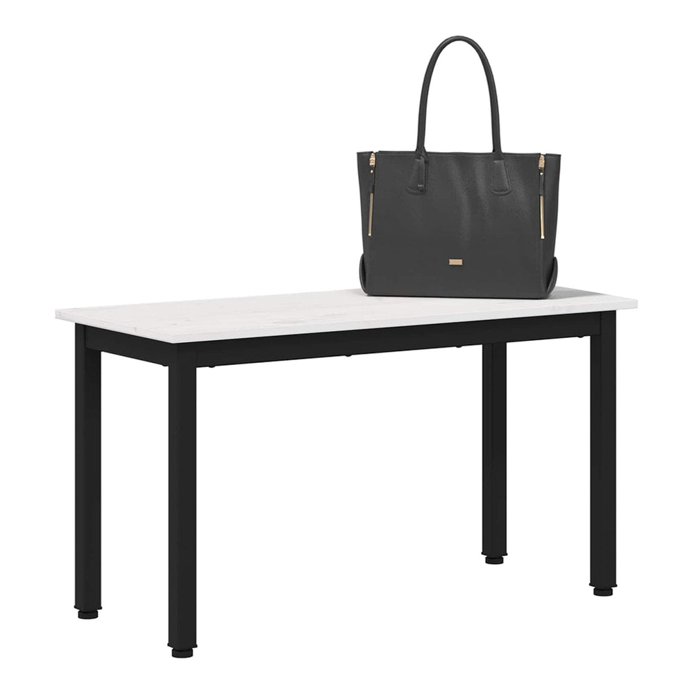 A black handbag rests on the white pine wood bench with black metal legs