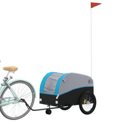 The black and blue bicycle trailer is hitched to the back wheel of a bicycle