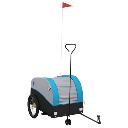 The bicycle trailer is black and blue with a red flag on a pole