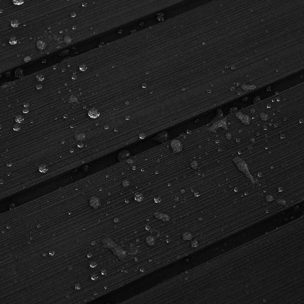 the boat mat, with water droplets on the dark grey and black striped surface