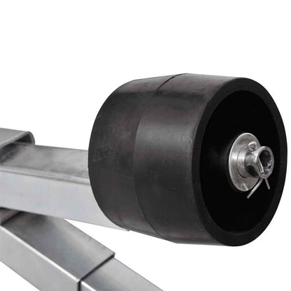 close up of a black keel roller on the boat trailer bottom support bracket