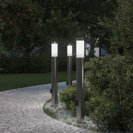vidaXL Bollard Lights with outlet in a garden setting at dusk