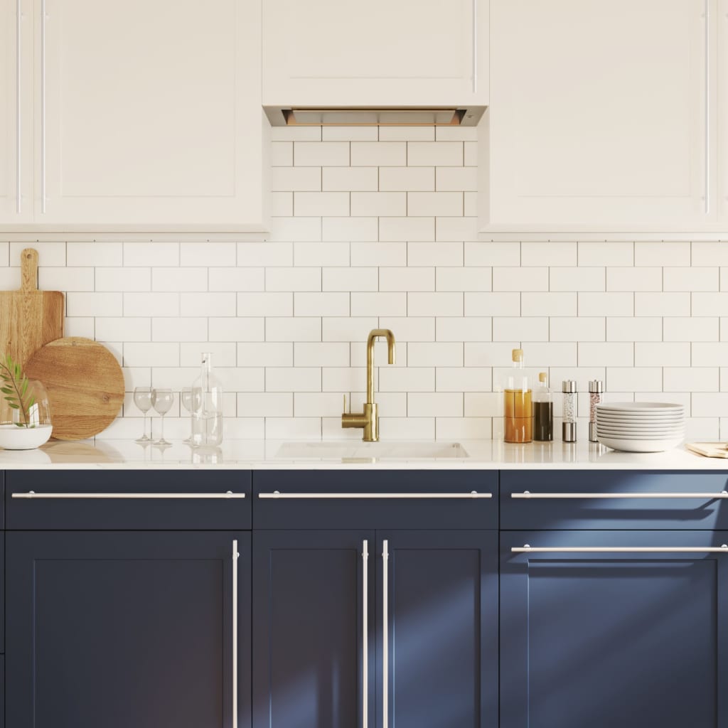 The cabinet handles installed on blue kitchen cupboards in a bright room