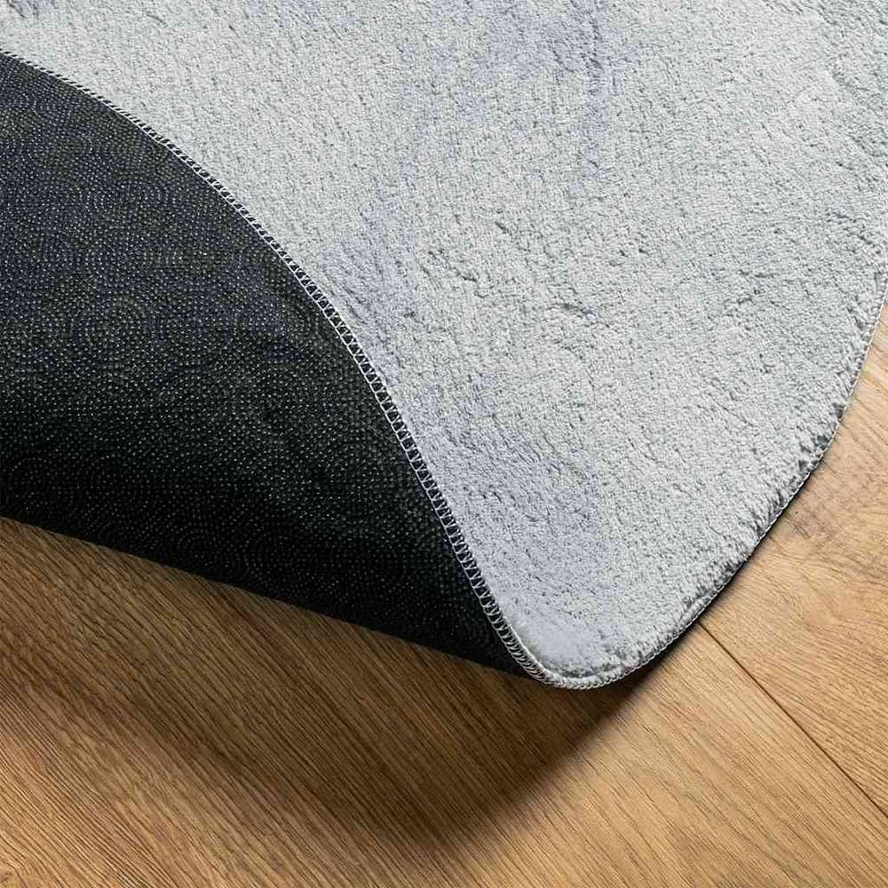 Underside of the grey polyester rug showing the non-slip backing