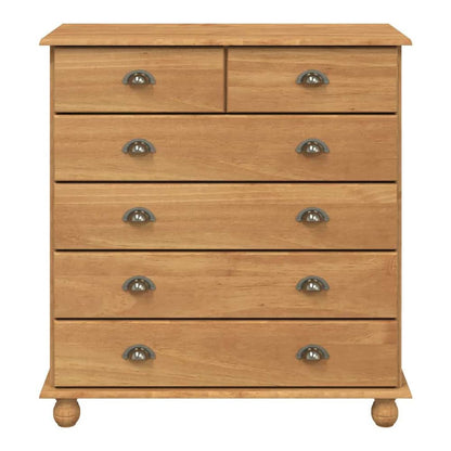 A close-up of the chest of drawers, highlighting the wood grain and the metal drawer handles