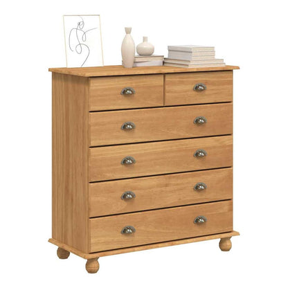 The brown solid pine wood chest of drawers with six drawers and round metal handles, displayed in a room setting