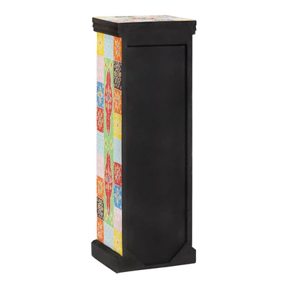 The chest of drawers showing the plain black back panel and the side pattern