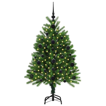 The green Christmas tree with stand, decorated with black baubles and lights
