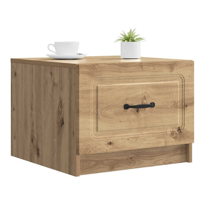 The coffee table with a drawer and a black handle, with a cup and plant on top