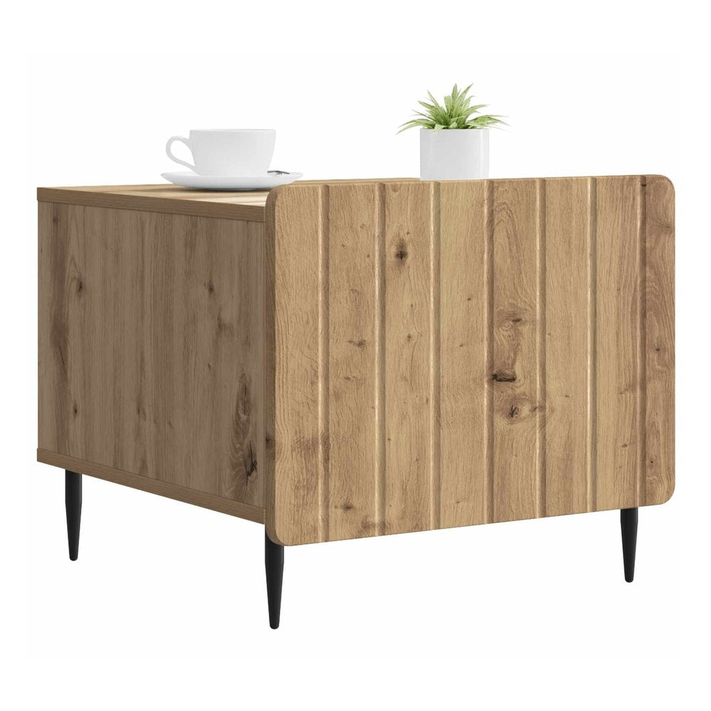 Front view of the artisan oak coffee table with a cup and plant on top