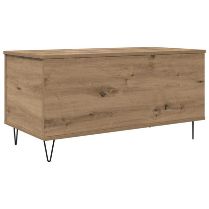 The coffee table has a natural wood grain finish and rests on four black hairpin legs