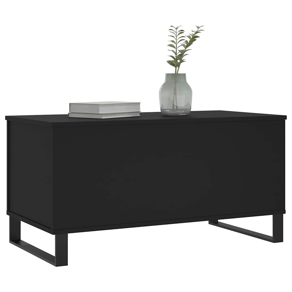The coffee table with a book and vase on its surface
