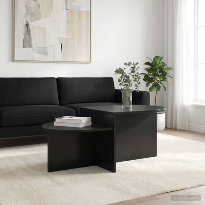 The black coffee table in a living room with a sofa and plants