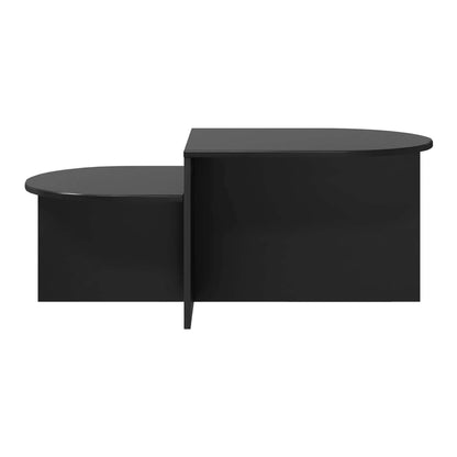 The black coffee table viewed from the side showing its asymmetrical shape