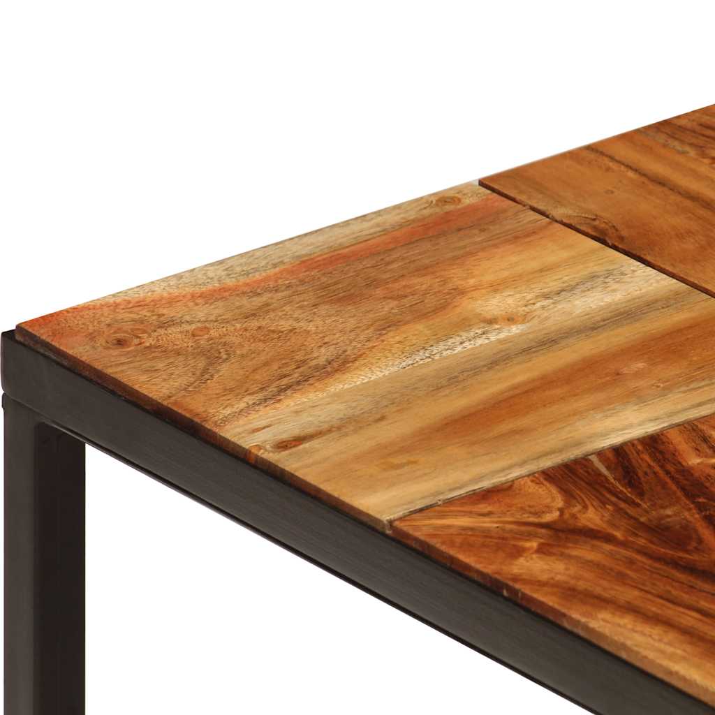 A close up of the corner of the coffee table showing the wood grain and metal frame