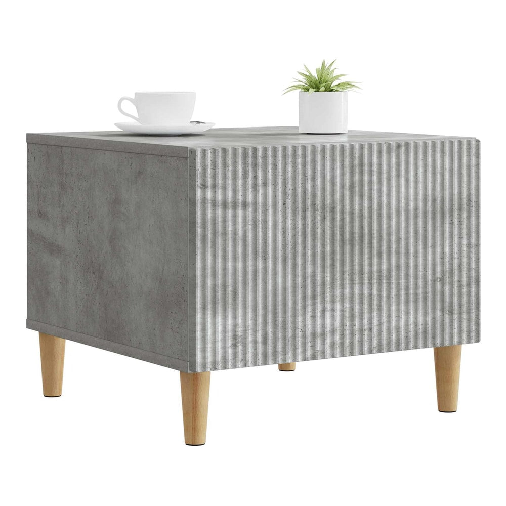 Grey engineered wood coffee table with a ribbed front panel and four tapered legs