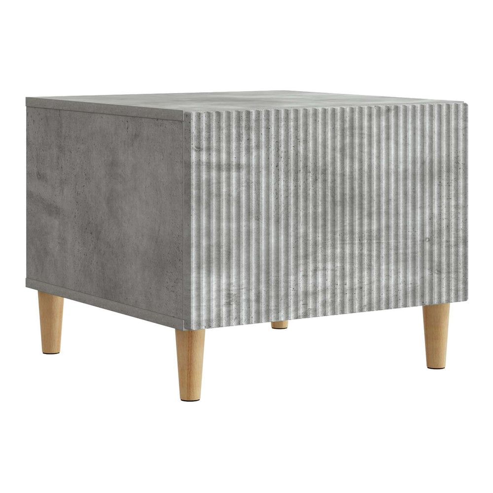 Concrete grey coffee table with ribbed front and wooden legs, shown from the side