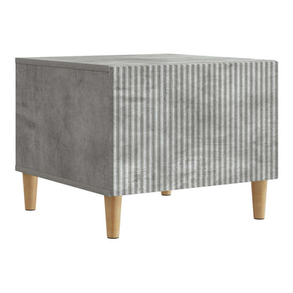 Concrete grey coffee table with ribbed front and wooden legs, shown from the side