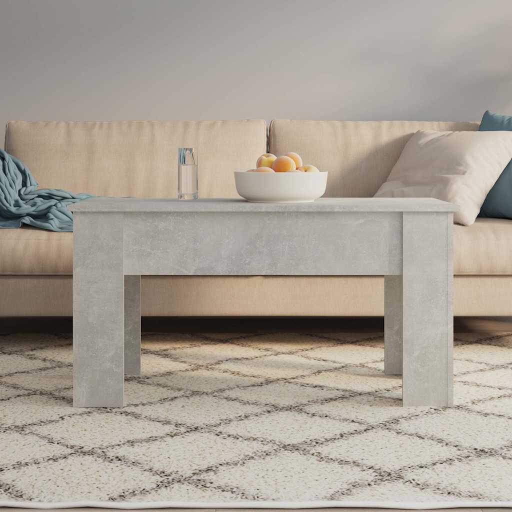 The coffee table with its top lowered, showing a glass and bowl on top