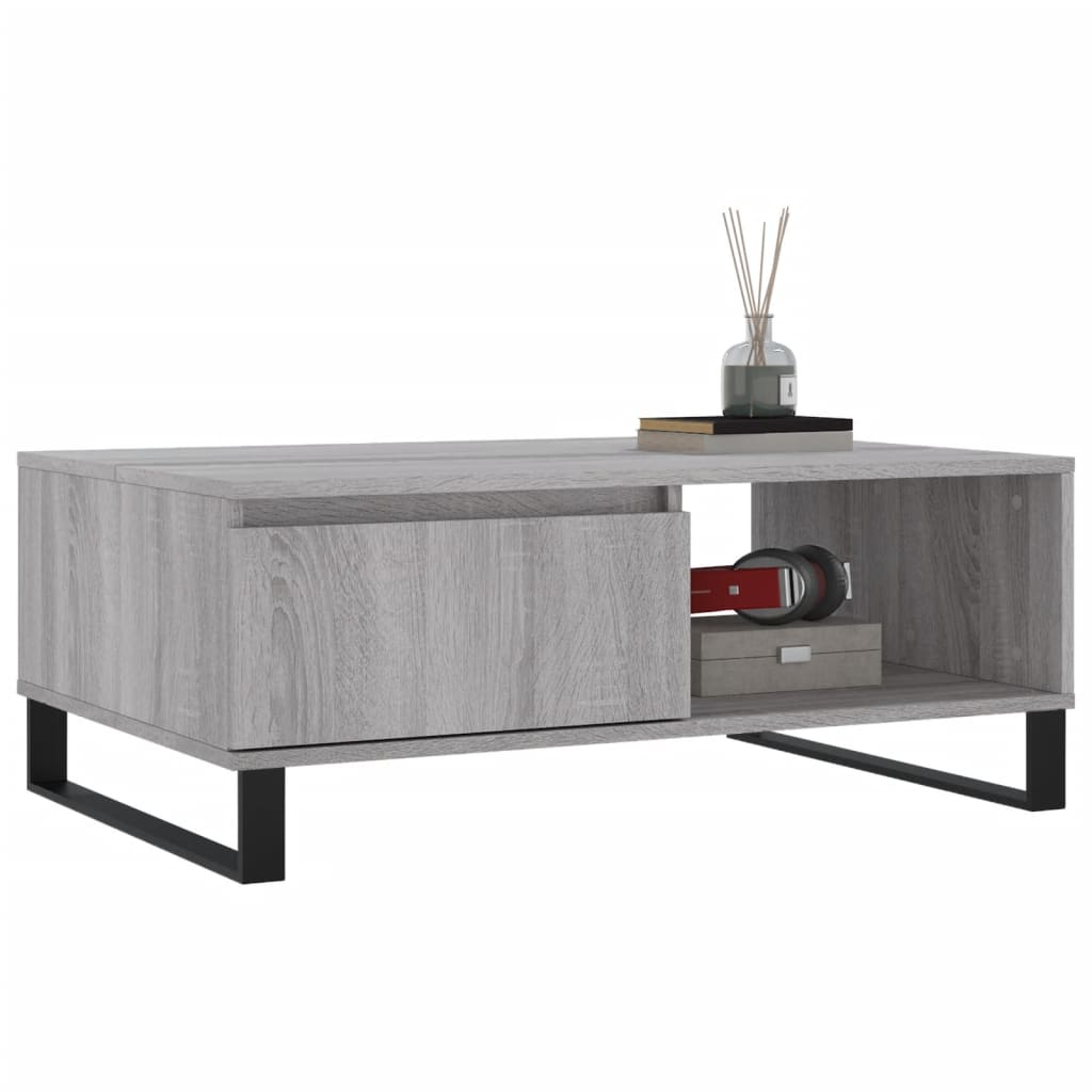 The coffee table with a drawer and open shelf, styled with books and headphones