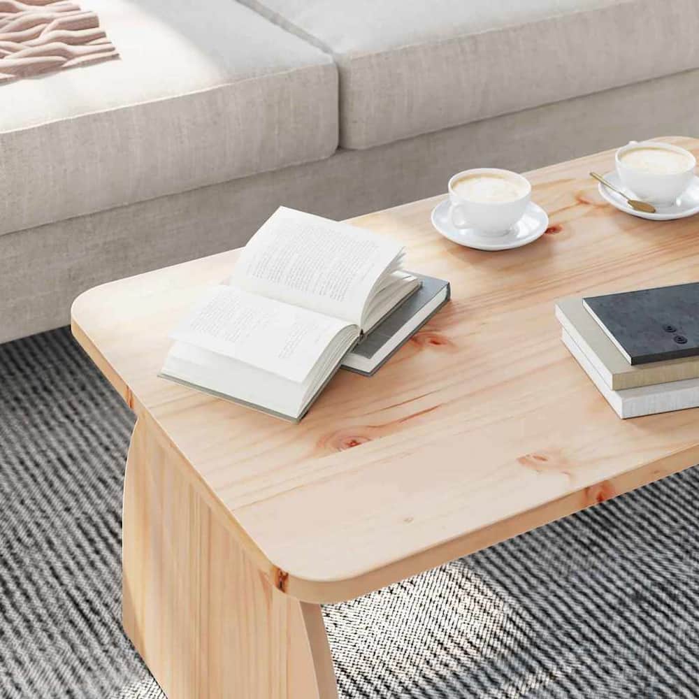 Close-up of the natural pine wood coffee table surface with books