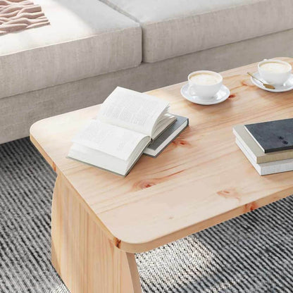 Close-up of the natural pine wood coffee table surface with books